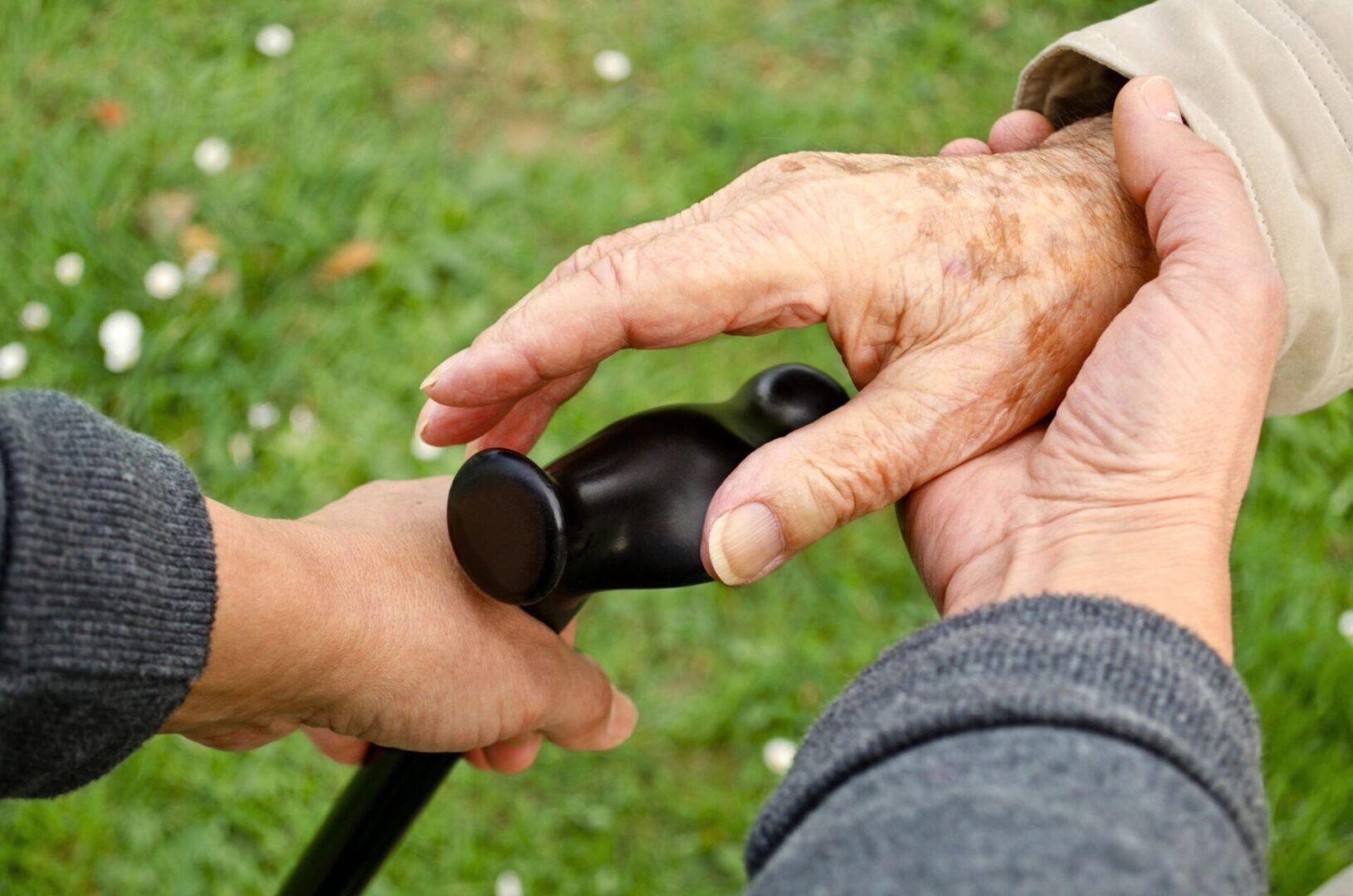 Giving a cane to an senior adult