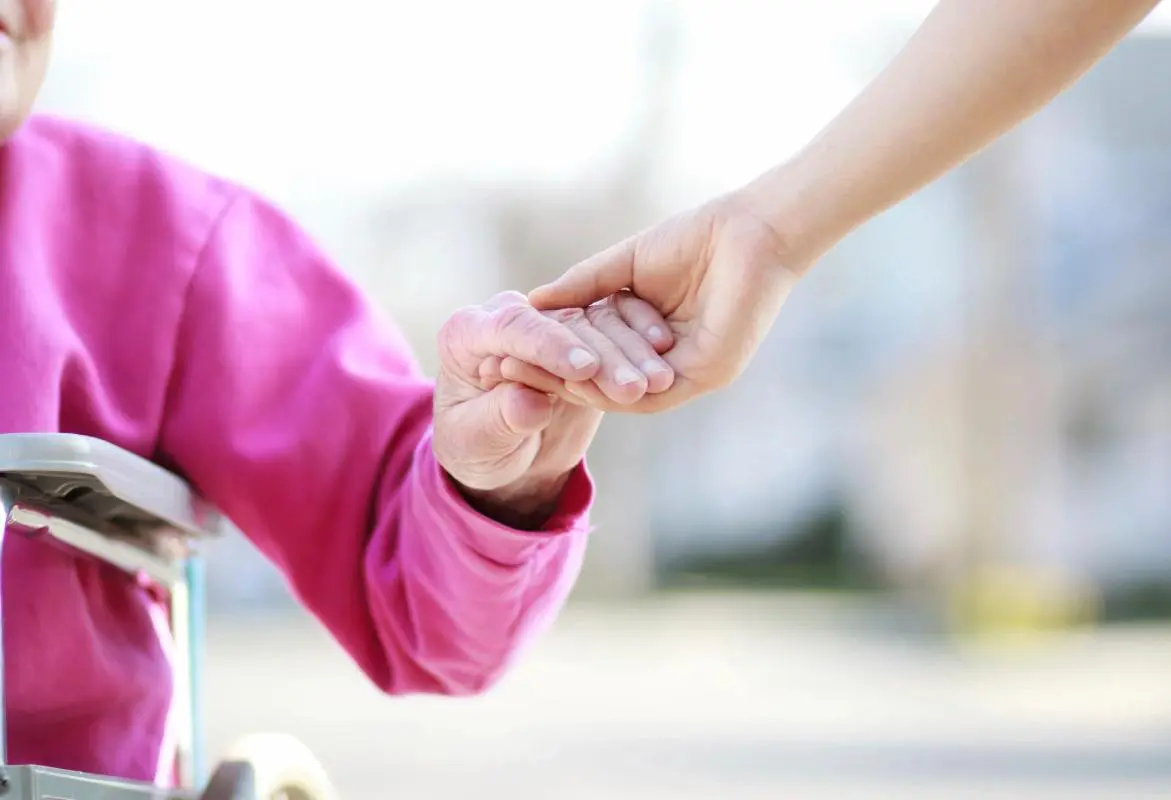 Holding old woman hand gesture of care